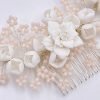 This stunning Romantic Bridal headpiece with flowers and blush beads adds style & sophistication. This chic and stylish comb embellished with ivory clay flowers and soft pearlescent beads on a silver finish. Hand wired onto a silver comb