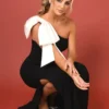 This design says simplicity with a twist. The giant satin shoulder bow steals the show, available in either a matching or contrast colour. A slim silhouette is crafted using our luxury Crepe fabric. Martini is a must-have. This dress is made-to-order especially for you. Available in over 50 colours, in either Crepe, Satin or Chiffon. Pictured in colour Black/Ivory & Merlot/Seashell. Model wears a size UK10.