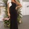 This design says simplicity with a twist. The giant satin shoulder bow steals the show, available in either a matching or contrast colour. A slim silhouette is crafted using our luxury Crepe fabric. Martini is a must-have. This dress is made-to-order especially for you. Available in over 50 colours, in either Crepe, Satin or Chiffon. Pictured in colour Black/Ivory & Merlot/Seashell. Model wears a size UK10.