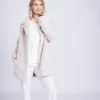 kennedy plush faux fur coat in pearl Woman wearing the Kennedy plush faux fur coat in pearl over white trousers, front view