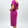 Back view showing the large bow and rosette on a fuchsia midi dress Back view showing the large bow and rosette on a fuchsia midi dress