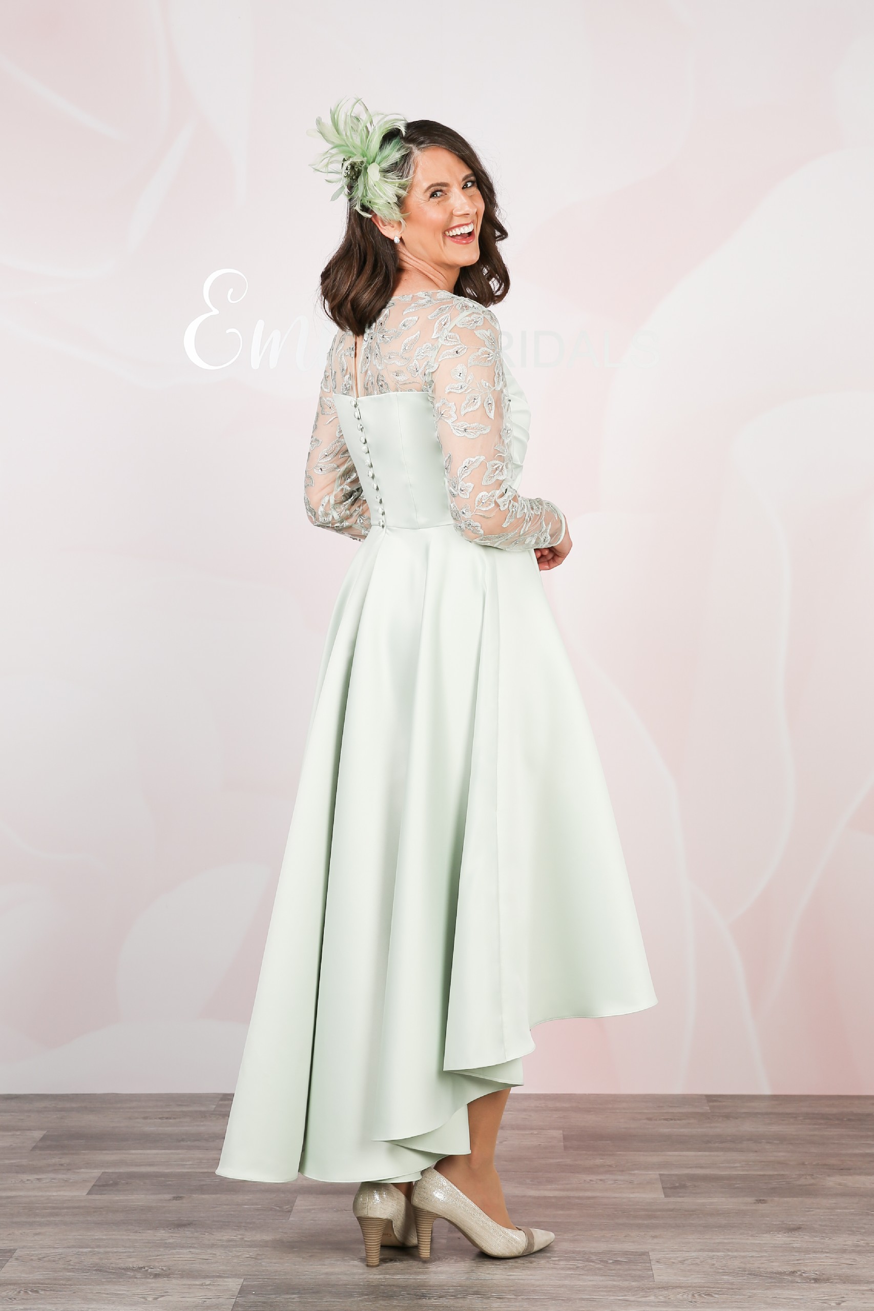 Back view with covered buttons and a dipped hem