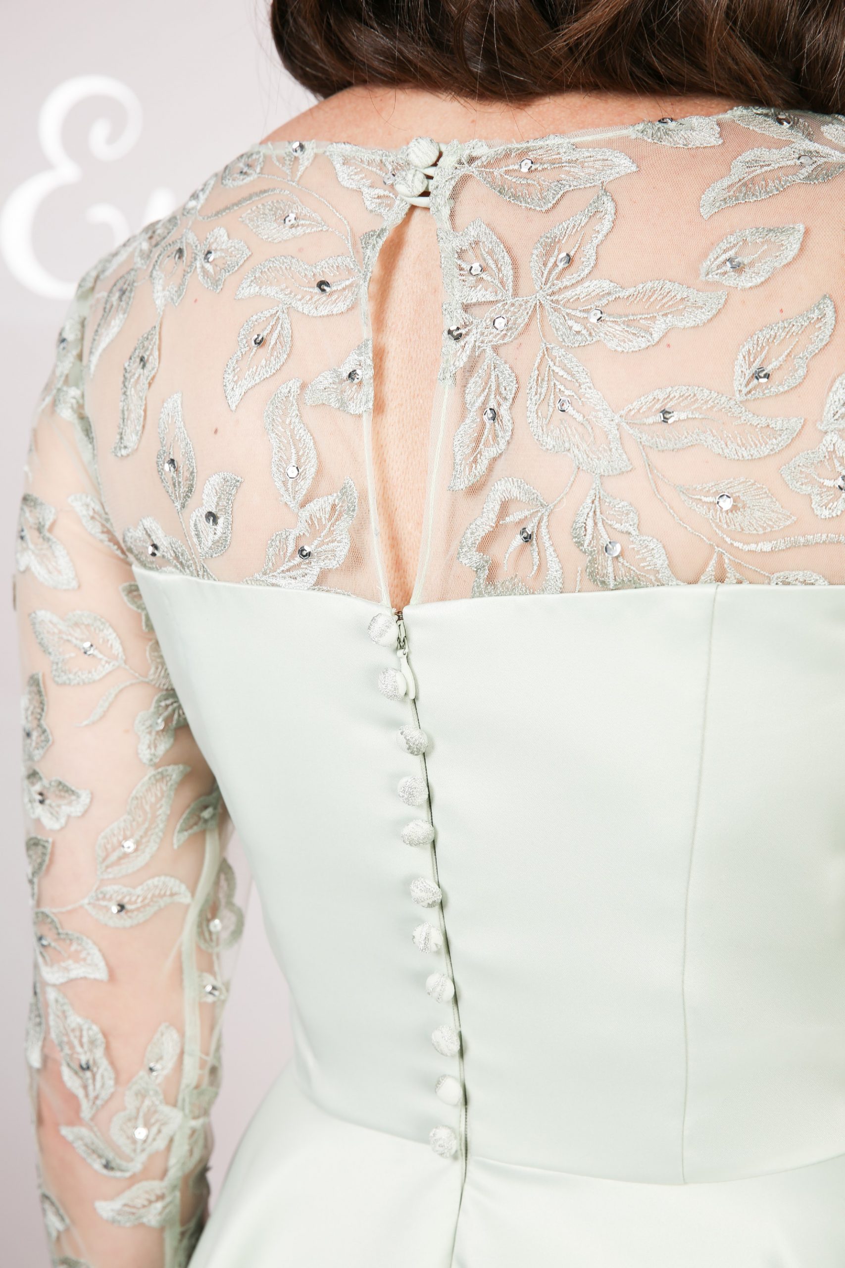 Covered buttons and keyhole on the back of the lace dress