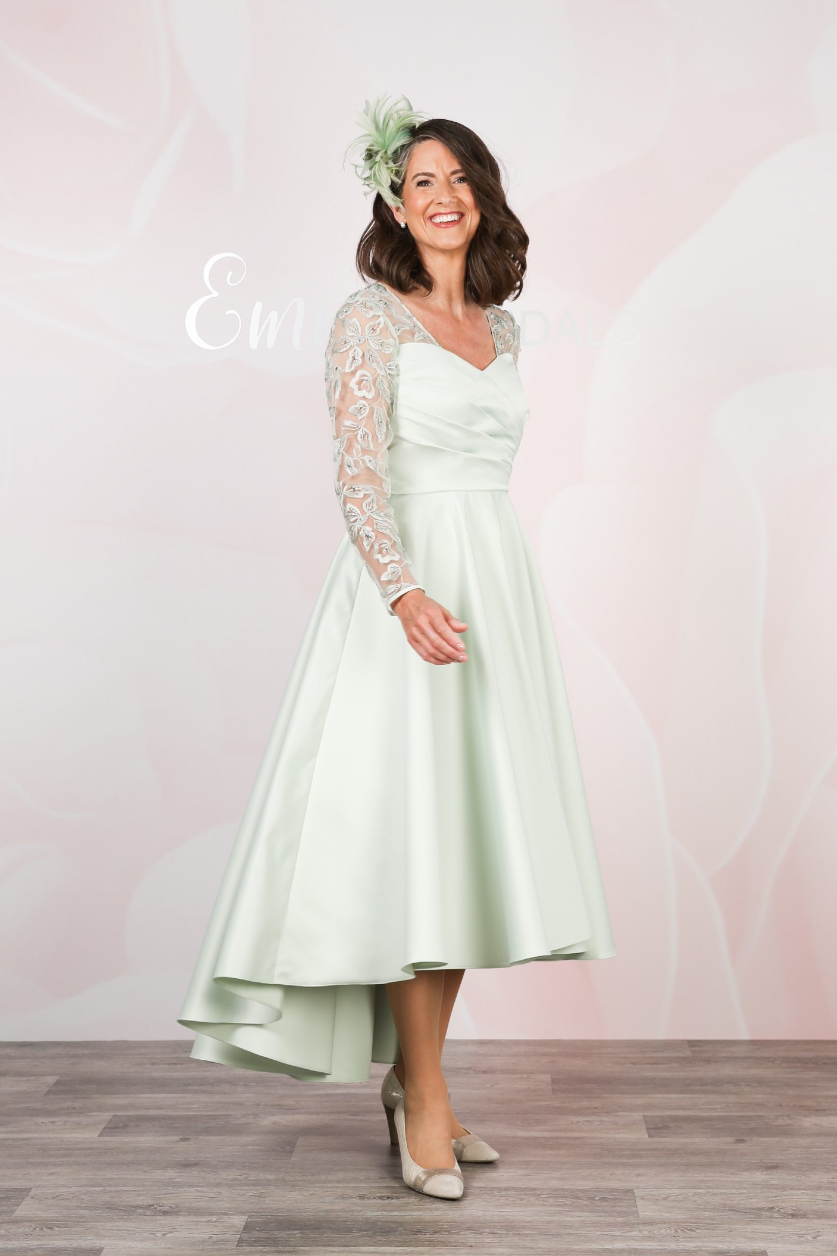 Side view showing the dipped hem of the mint green dress