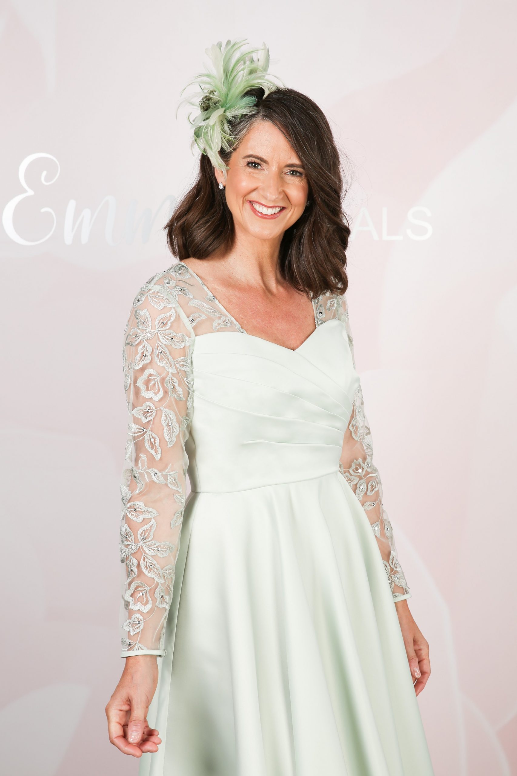Sheer embroidered lace sleeves on a mint green mother of the bride dress
